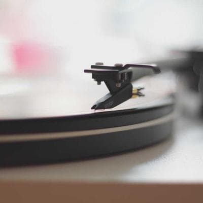 A smiling female teacher wearing a hijab.